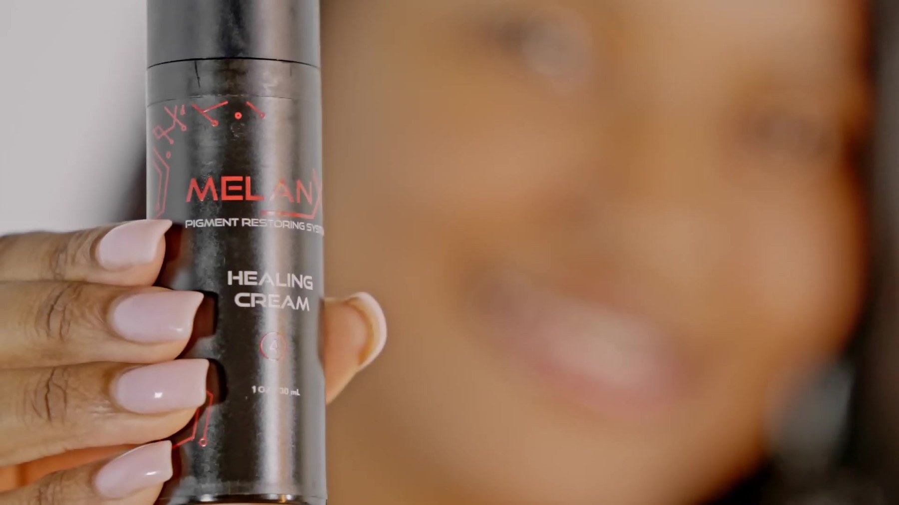 MelanX Healing Cream held in the hand